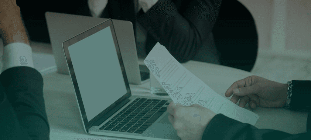 Business professionals reviewing brochures and documents at a meeting