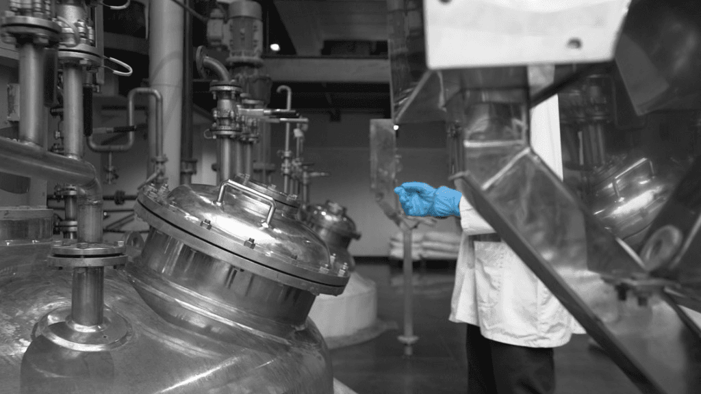 Pharmaceutical manufacturing equipment with technician in a clean production facility