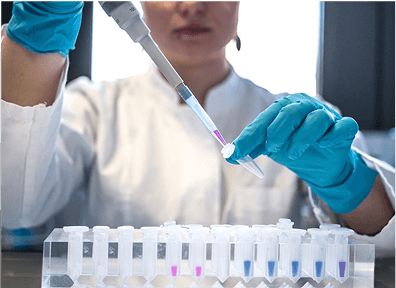 Scientist handling sample vials in a lab